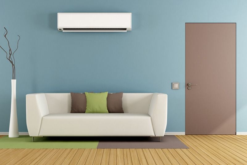 Image of ductless system above couch. Why Ductless Is the Way to Go.