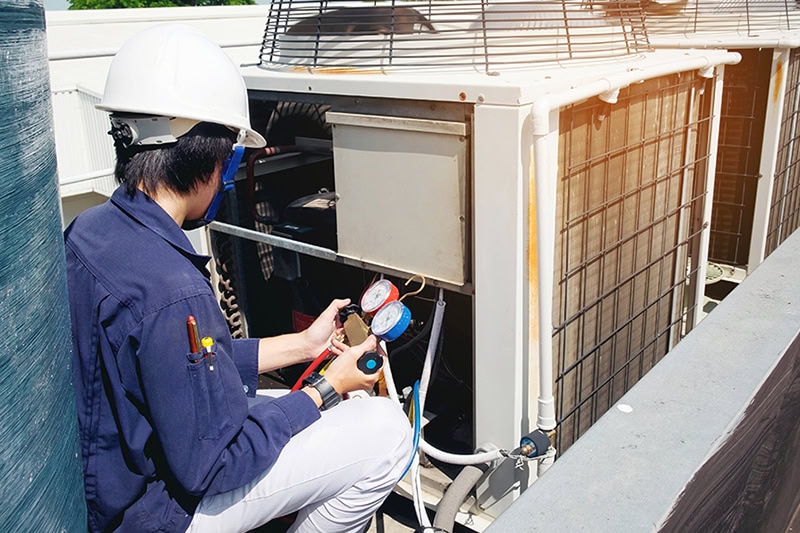 HVAC technician working on unit.