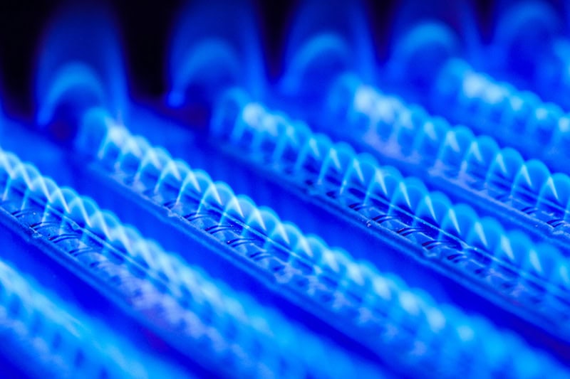 What Is That Burning Smell Coming From My Furnace? Close up photo of blue heated coils from inside a furnace.
