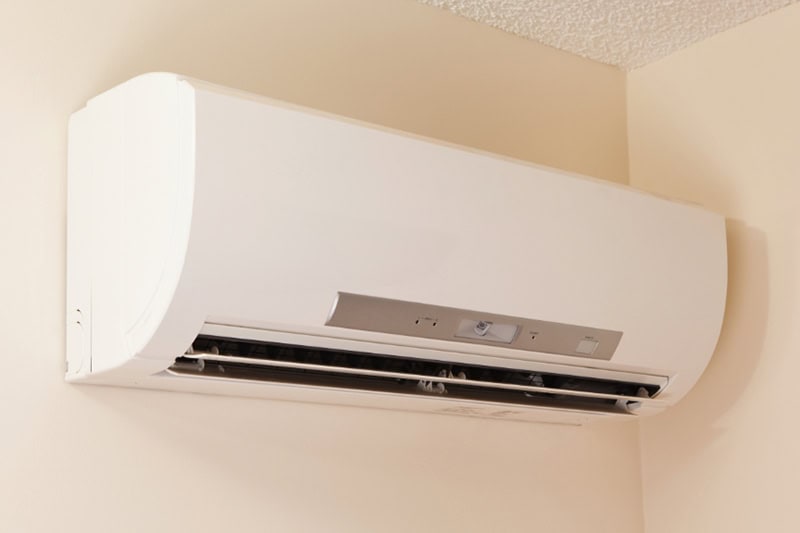 How Much Does it Cost to Install a Ductless Mini Split? A wall-mount mini-split heating and air conditioning unit installed in a new house.